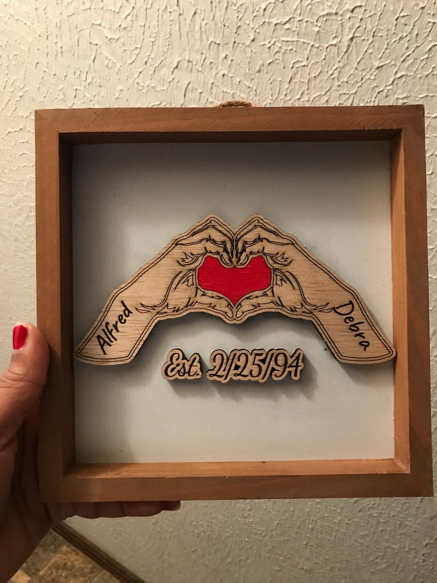 Hands Forming Heart with Anniversary Date Sign