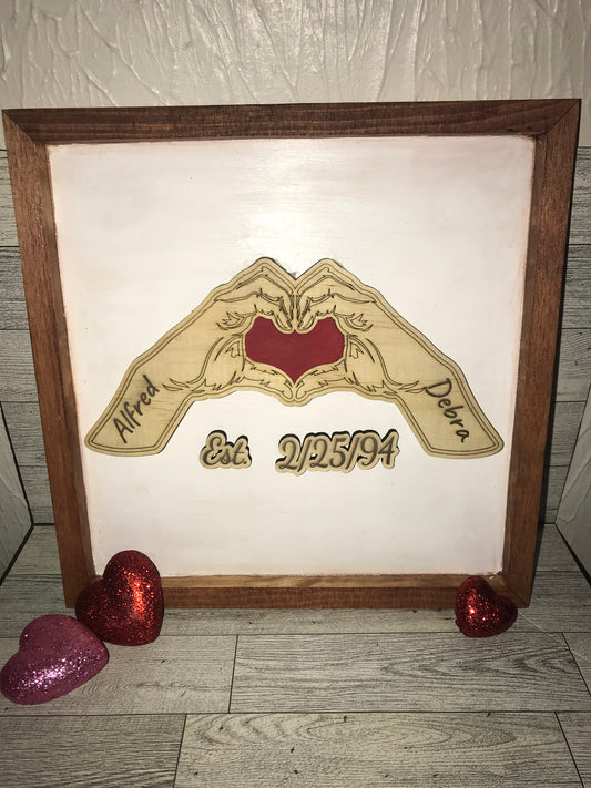 Hands Forming Heart with Anniversary Date Sign